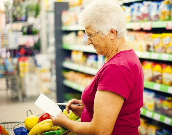 Seniorin im Supermarkt — Stockfoto