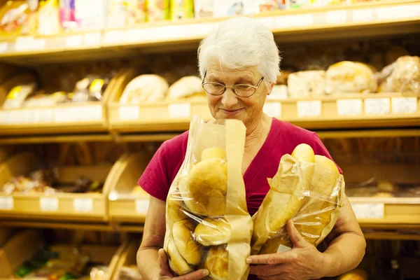 Starší žena v supermarketu — Stock fotografie