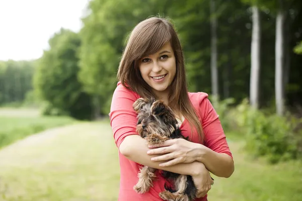 Smiling woman holding cute puppy Stock Picture