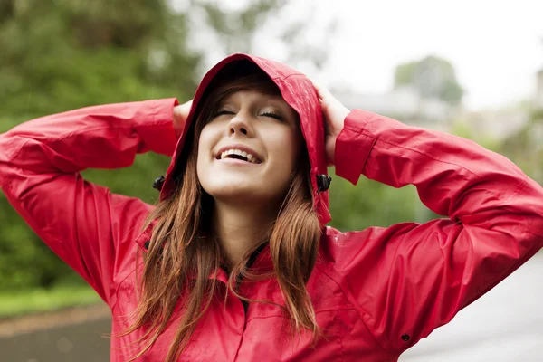 Young woman in raincoat Stock Image