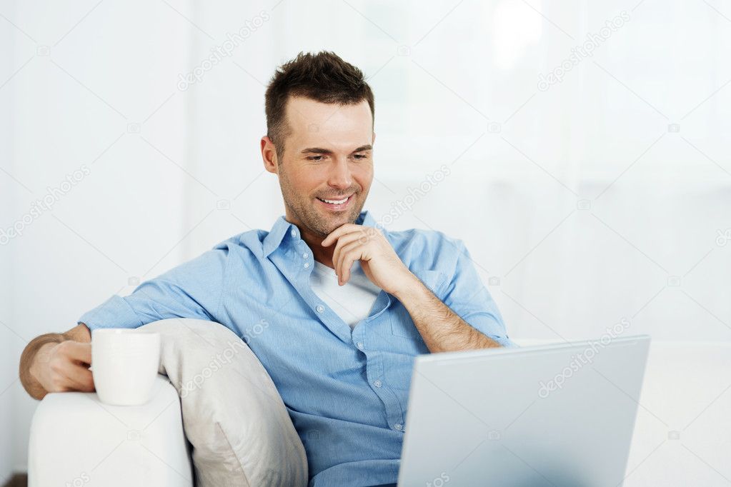 Man with laptop and cup of coffee