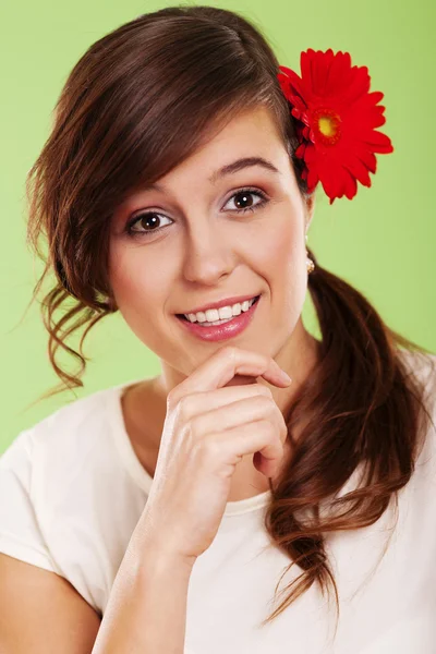 Mulher sorridente com flor no cabelo — Fotografia de Stock