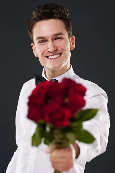 Homem segurando rosas vermelhas — Fotografia de Stock