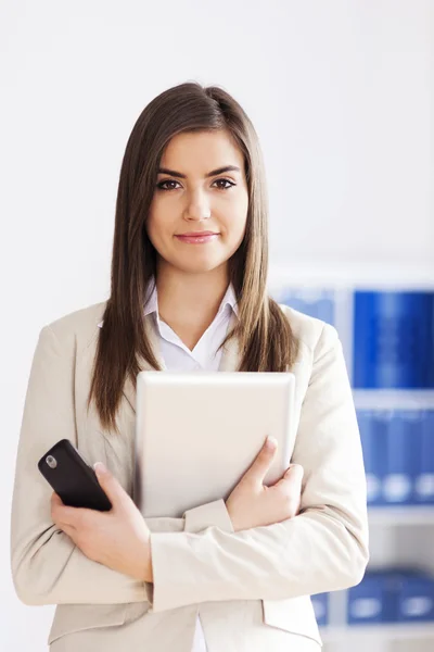 Businesswoman holding digital tablet and mobile phone — Stock Photo, Image