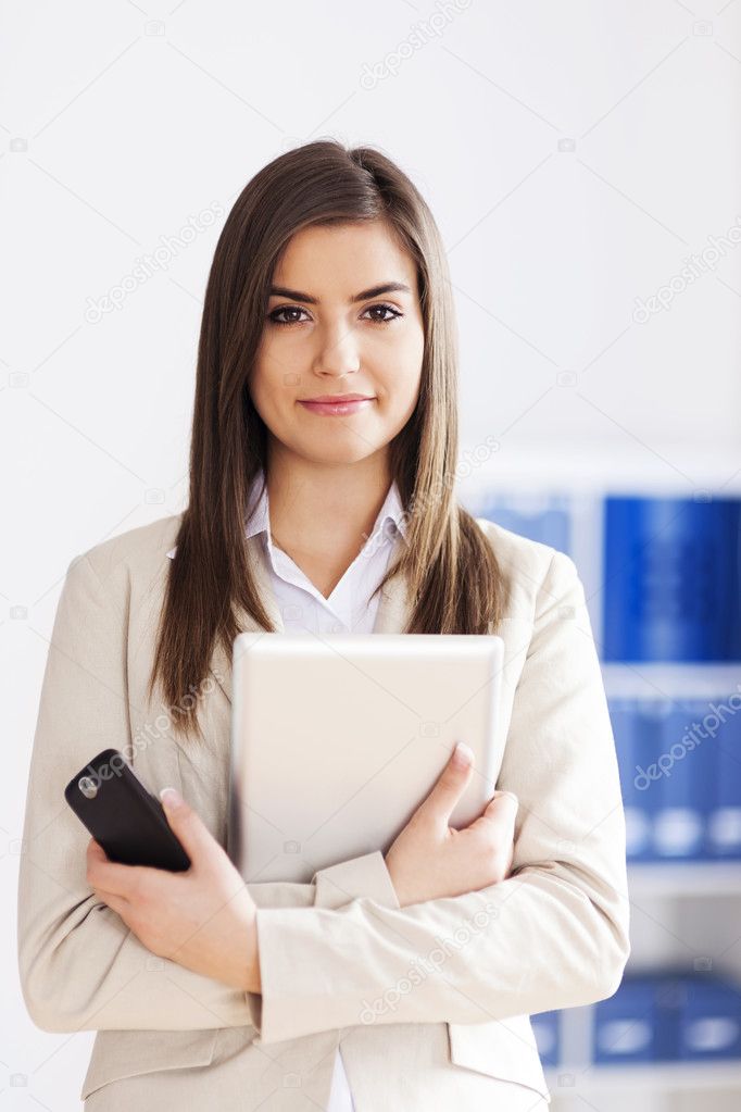 Businesswoman holding digital tablet and mobile phone