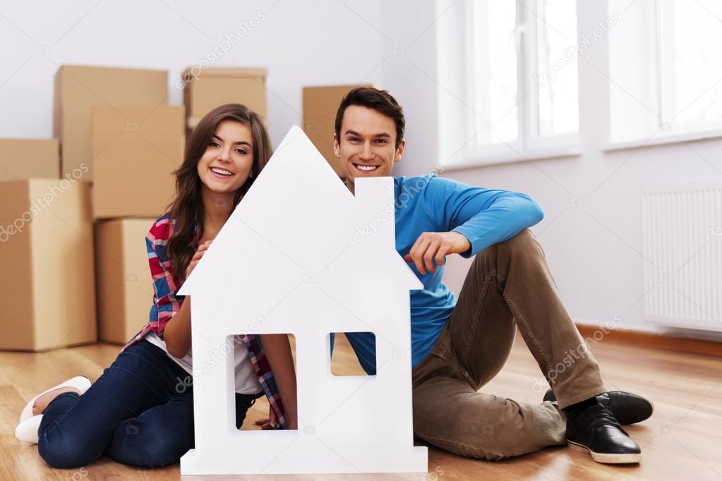 Young couple with house signs