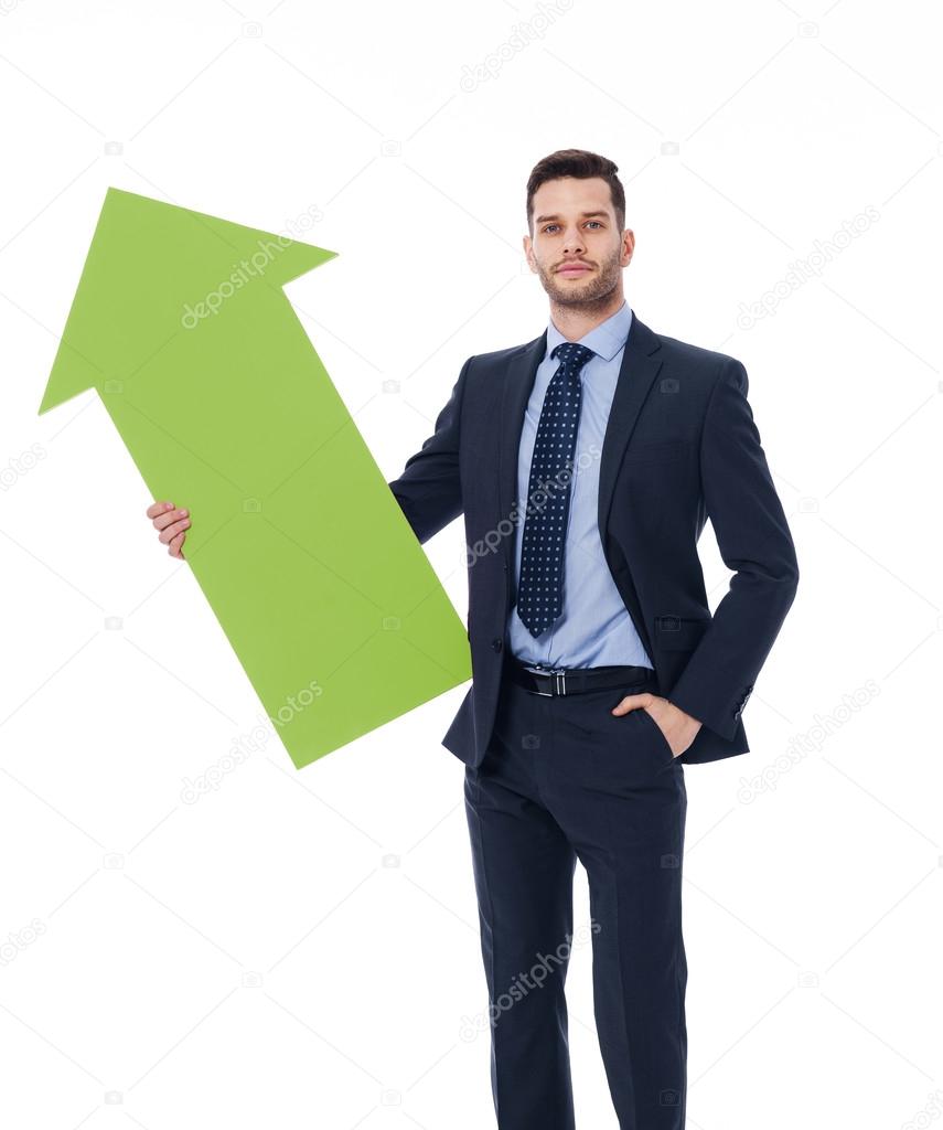Focus young male holding green sign of arro