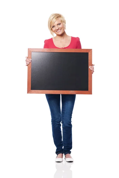 Smiling woman holding blackboard — Stock Photo, Image