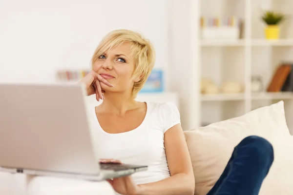 Portrait of pensive woman with laptop — Stock Photo, Image