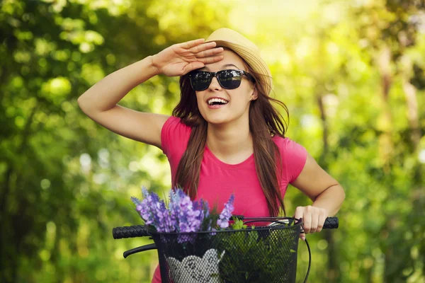 Mujer feliz con bicicleta viendo algo —  Fotos de Stock