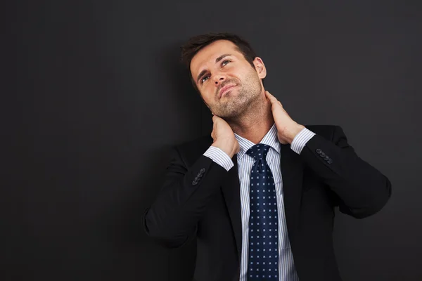 Businessman having pain in the neck — Stock Photo, Image