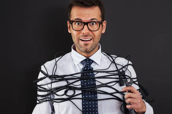 Businessman with wires around his body — Stock Photo, Image