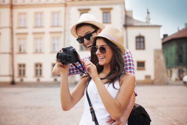 Cute couple looking on their photos on camera clipart