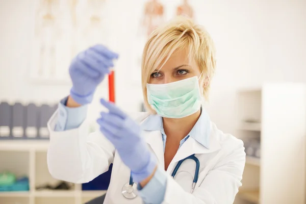 Female doctor analyzing results of medical test — Stock Photo, Image