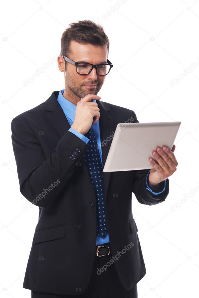Businessman working on his digital tablet
