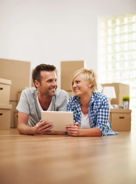 Couple at the new apartment with digital tablet — Stock Photo, Image