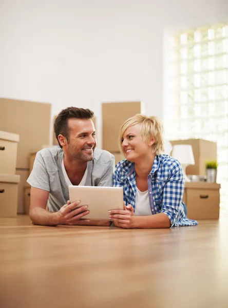 Paar in der neuen Wohnung mit digitalem Tablet — Stockfoto