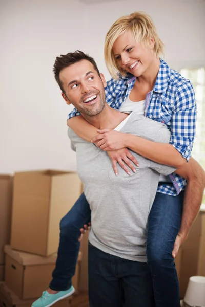 Man picking up his wife in their new home — Stock Photo, Image