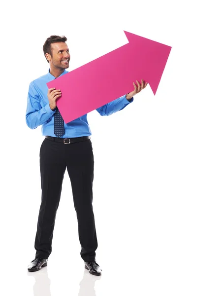 Business man holding pink arrow — Stock Photo, Image