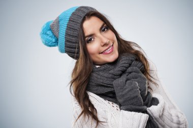 Smiling woman wearing fashion winter clothes clipart