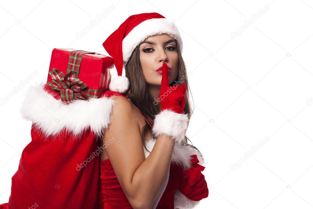 Sexy woman giving christmas gifts from sack of santa claus
