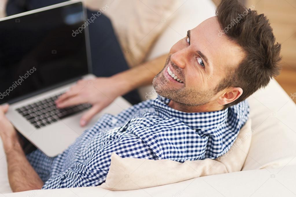 Smiling man using computer