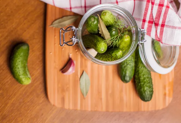 Cucumbers in rustic jar — Stock Photo, Image