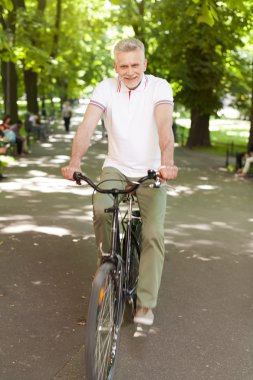 Olgun adam parkta Bisiklete binme