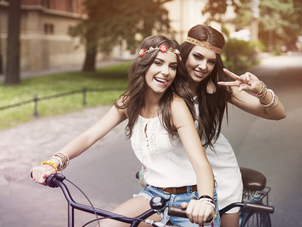 Boho girls on the tandem bicycle