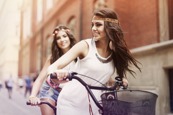 Boho girls riding a bike