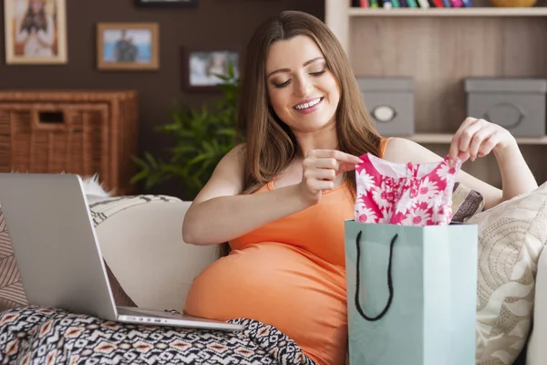 Futura mãe preparando roupas para bebê — Fotografia de Stock