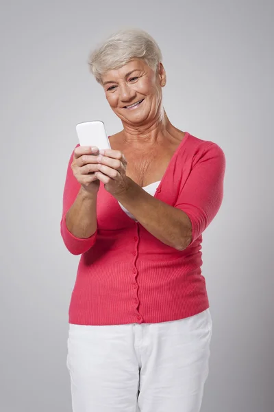 Seniorin nutzt Smartphone — Stockfoto