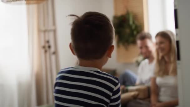 Little Boy Runs His Family Christmas Morning Shot Red Helium — Stock Video