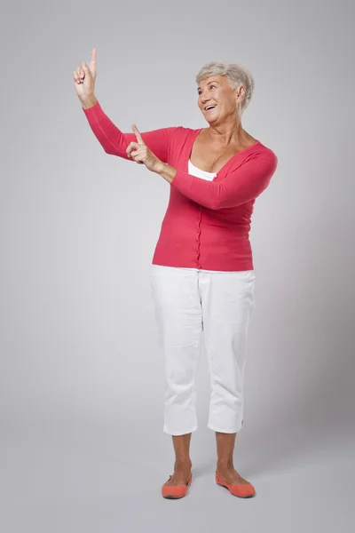 Senior woman pointing — Stock Photo, Image