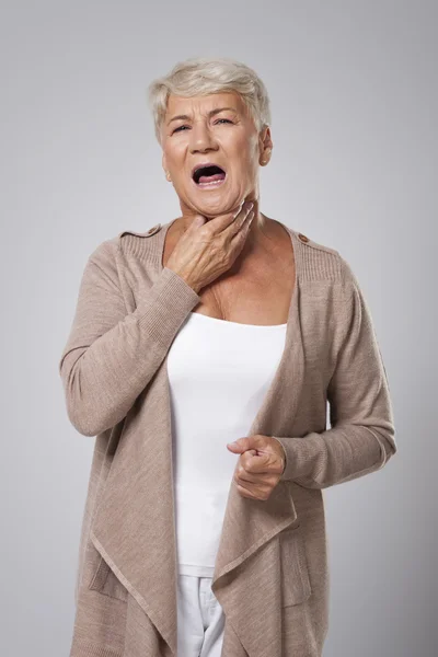 Senior woman has with sore throat — Stock Photo, Image