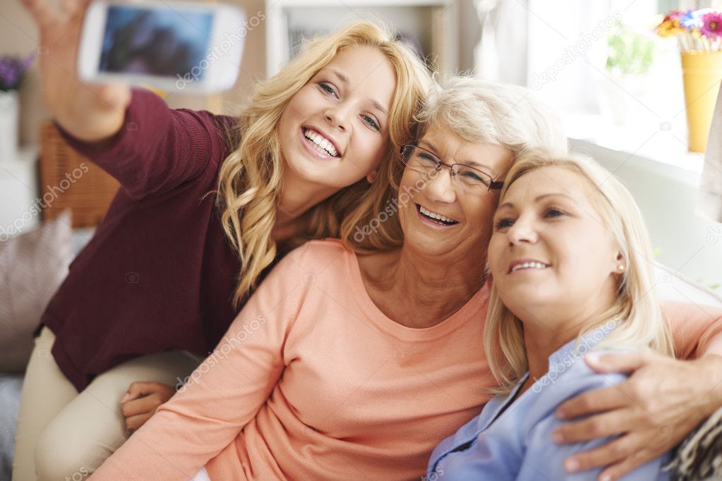 Girl taking selfie with mom and grandma