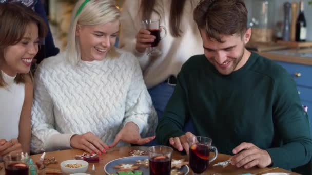 Friends decorating cookies and drinking mulled wine. Shot with RED helium camera in 8K — Stock Footage Friends Decorating Cookies Drinking Mulled Wine Shot Red Helium Camera Royalty Free Stock Footage