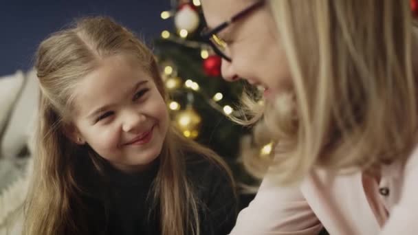 Video of grandma packing Christmas present with little granddaughter. Shot with RED helium camera in 8K. — Stock Footage Video Grandma Packing Christmas Present Little Granddaughter Shot Red Helium Royalty Free Stock Footage