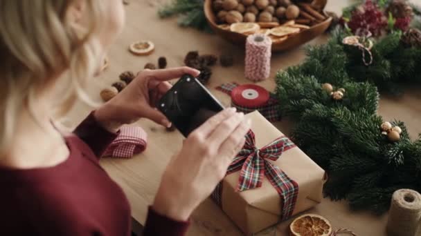 Blonde Woman Packing Christmas Present Shot Red Helium Camera — Stock Video