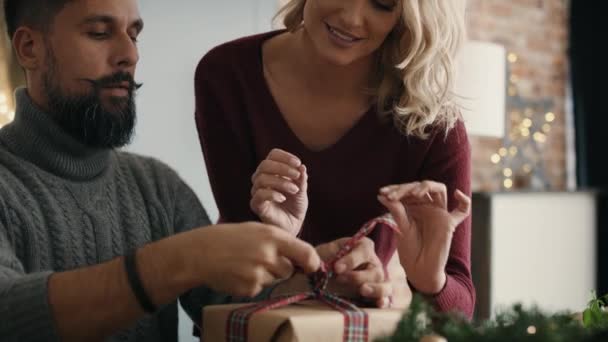 Happy couple packing Christmas gift. Shot with RED helium camera in 8K — Stock Footage Happy Couple Packing Christmas Gift Shot Red Helium Camera Video Clip
