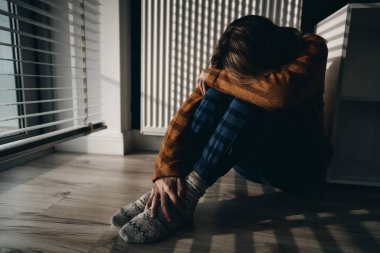 Yerde oturan sorunlu bir kadın.                               