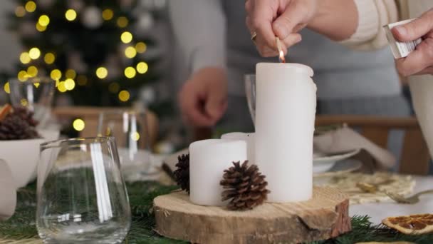 Close up woman lights a candle in Christmas Eve. Shot with RED helium camera in 8K — Stock Footage Close Woman Lights Candle Christmas Eve Shot Red Helium Camera Royalty Free Stock Footage