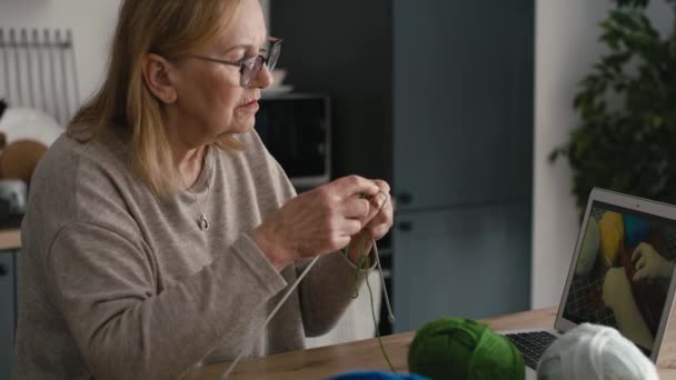 Ανώτερη Καυκάσια Γυναίκα Στο Σπίτι Μαθαίνει Πώς Πλέκει Από Βίντεο — Αρχείο Βίντεο