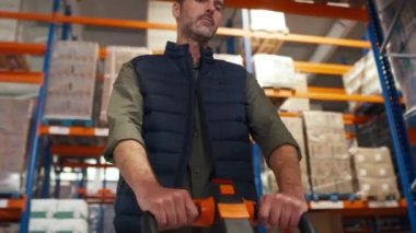 Depoda forklift çeken yetişkin bir beyaz adam. 8K 'da kırmızı helyum kamerayla çekildi.. 