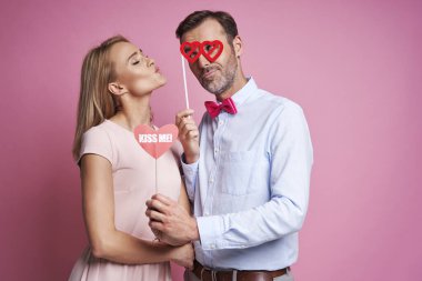 Caucasian mature couple in love posing  on pink background