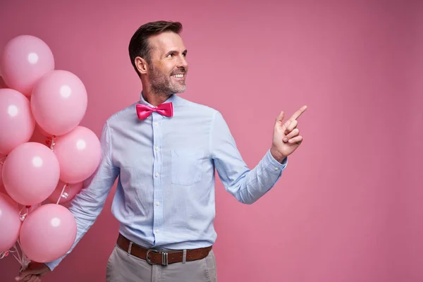 Happy Caucasian Man Holding Pink Balloons Pointing — Photo