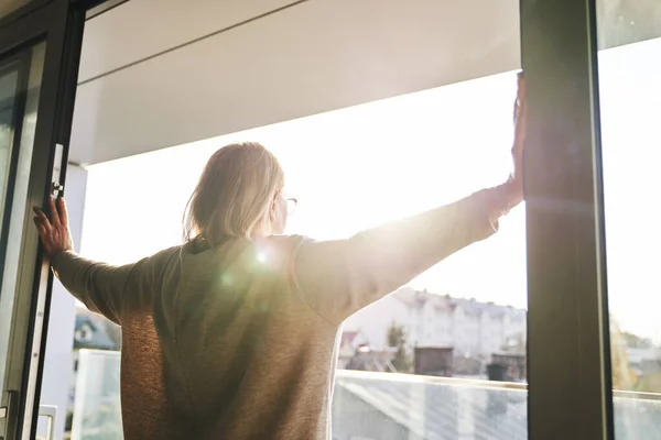 Back View Senior Woman Opening Balcony Doors Beams Sun — Stockfoto