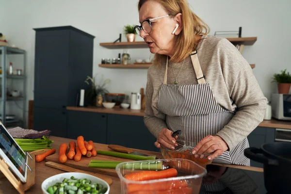 Caucasian Senior Woman Cooking Chatting Earphones — Stock Photo, Image