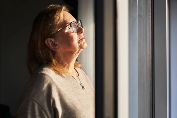 Close Senior Caucasian Woman Catching Sunbeams Next Window — Stock Photo, Image