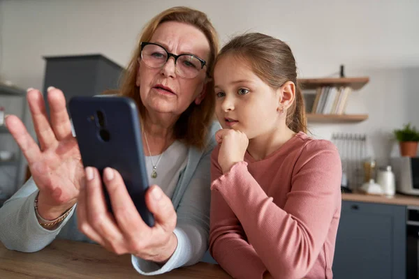 Close Grandmother Her Granddaughter Using Smarphone Together — стоковое фото